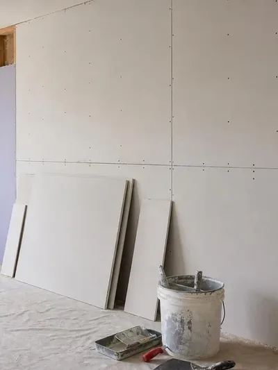 Moisture-resistant board and insulation staged before drywall closes the walls