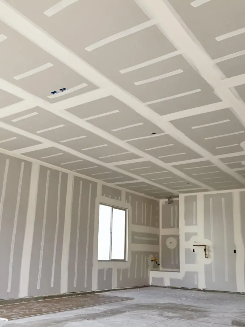 Taped drywall on an attached-garage wall and ceiling separation