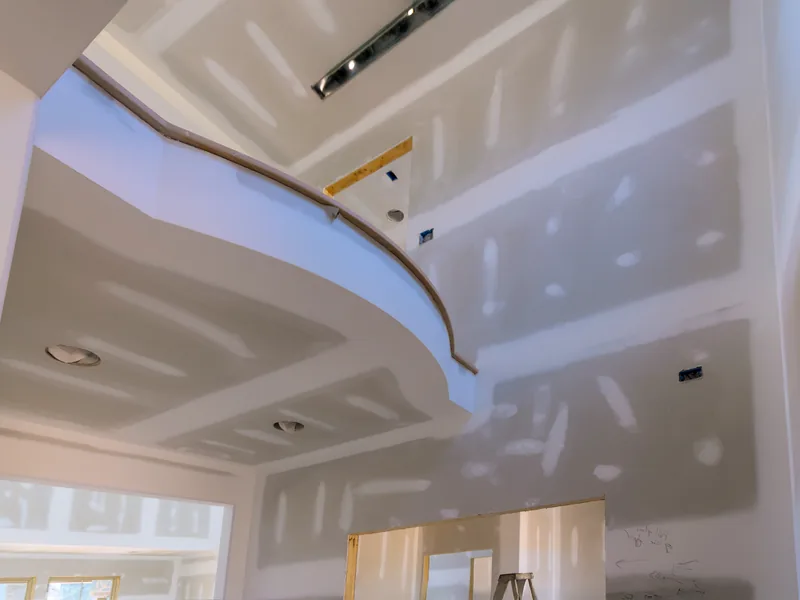 A vaulted ceiling taped out with one length of tape still hanging loose