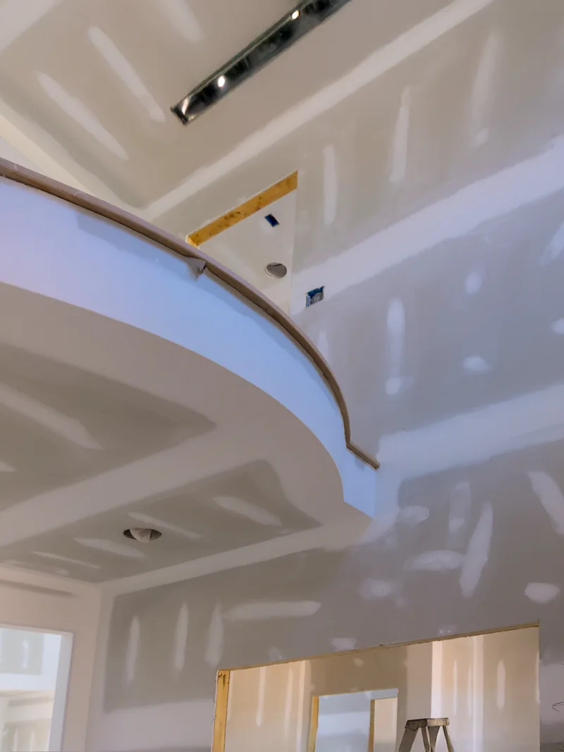 A vaulted ceiling taped out with one length of tape still hanging loose