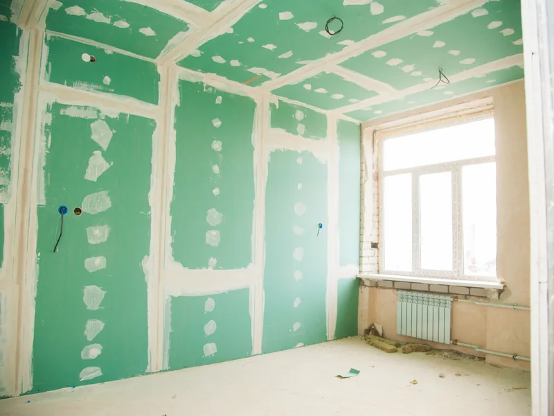 A room lined throughout in green moisture-resistant board