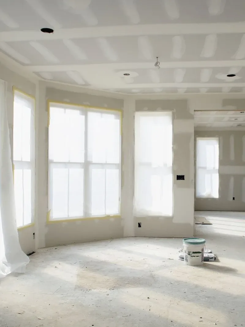 Smooth finished drywall walls under strong daylight